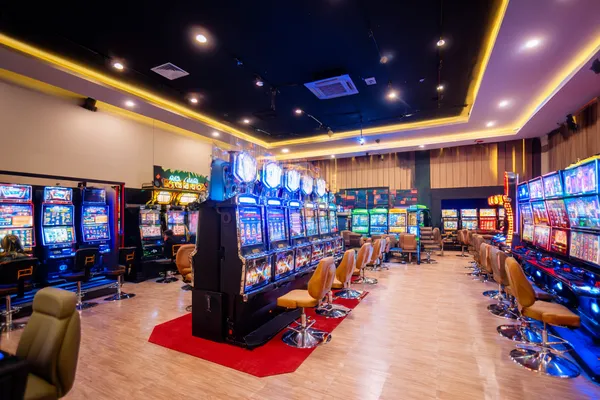 A glamorous woman holding casino chips in a neon-lit environment, representing the premium online casino atmosphere of 2777DET.